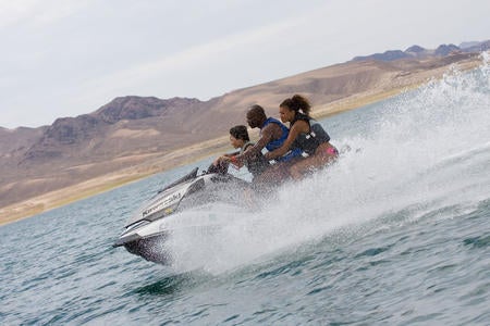 Jason Britton and his family kick up some wake on an Ultra 260LX.