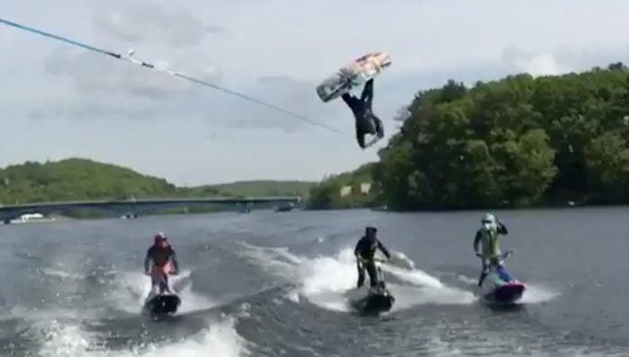 wakeboarder jumps over PWC riders
